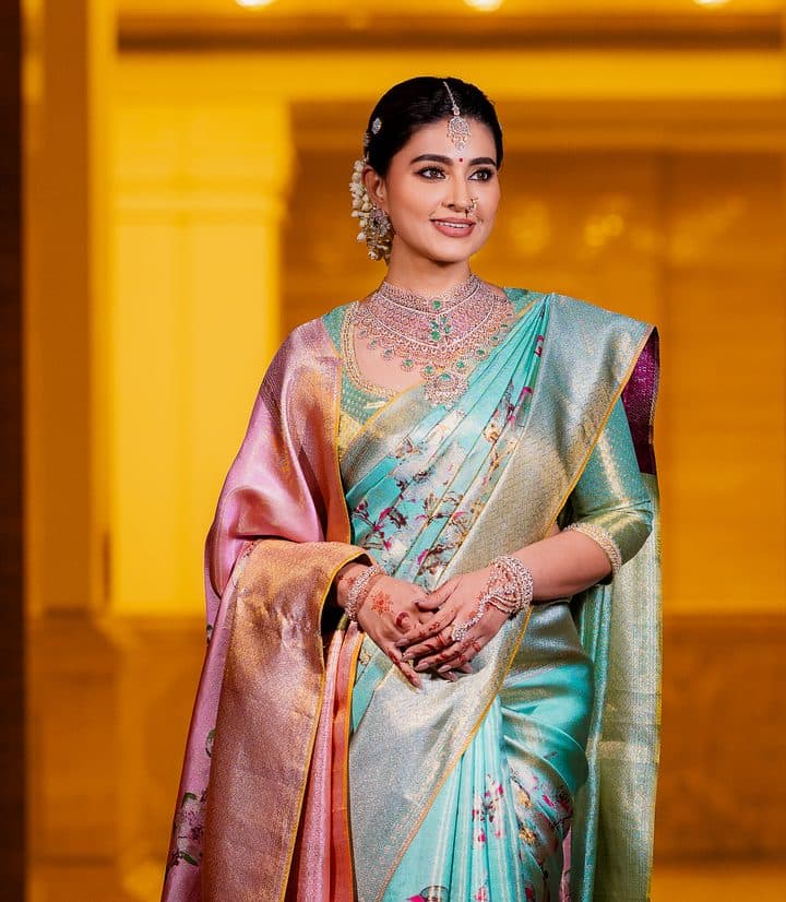 Model in an aqua and rose-pink silk saree
