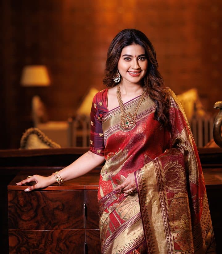 Model in a maroon Kanjivaram with a broad gold zari pallu