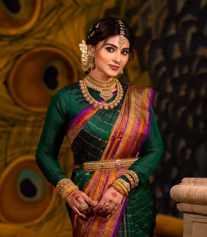 Bride in a bottle-green Kanjivaram with a magenta border