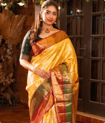 Model in a yellow Kanjivaram with a green and red border