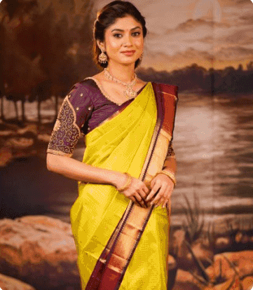 Model in a yellow silk saree with a maroon border